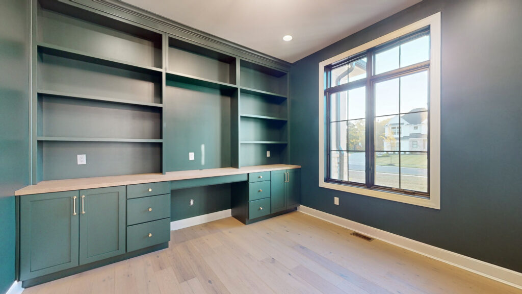 Study with custom green cabinetry